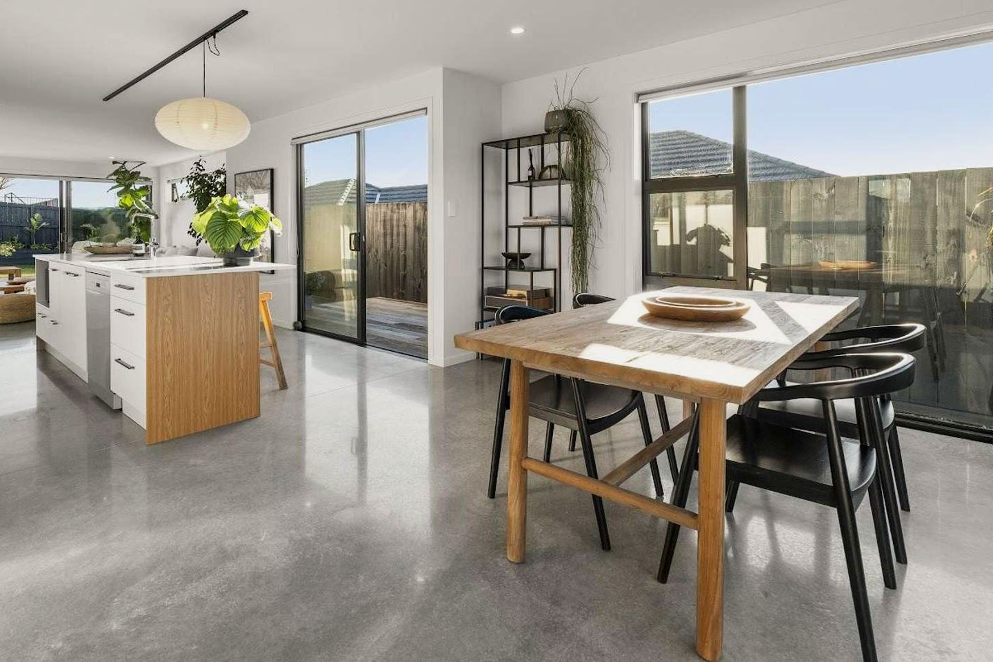 Open-plan kitchen and dining with polished concrete floors